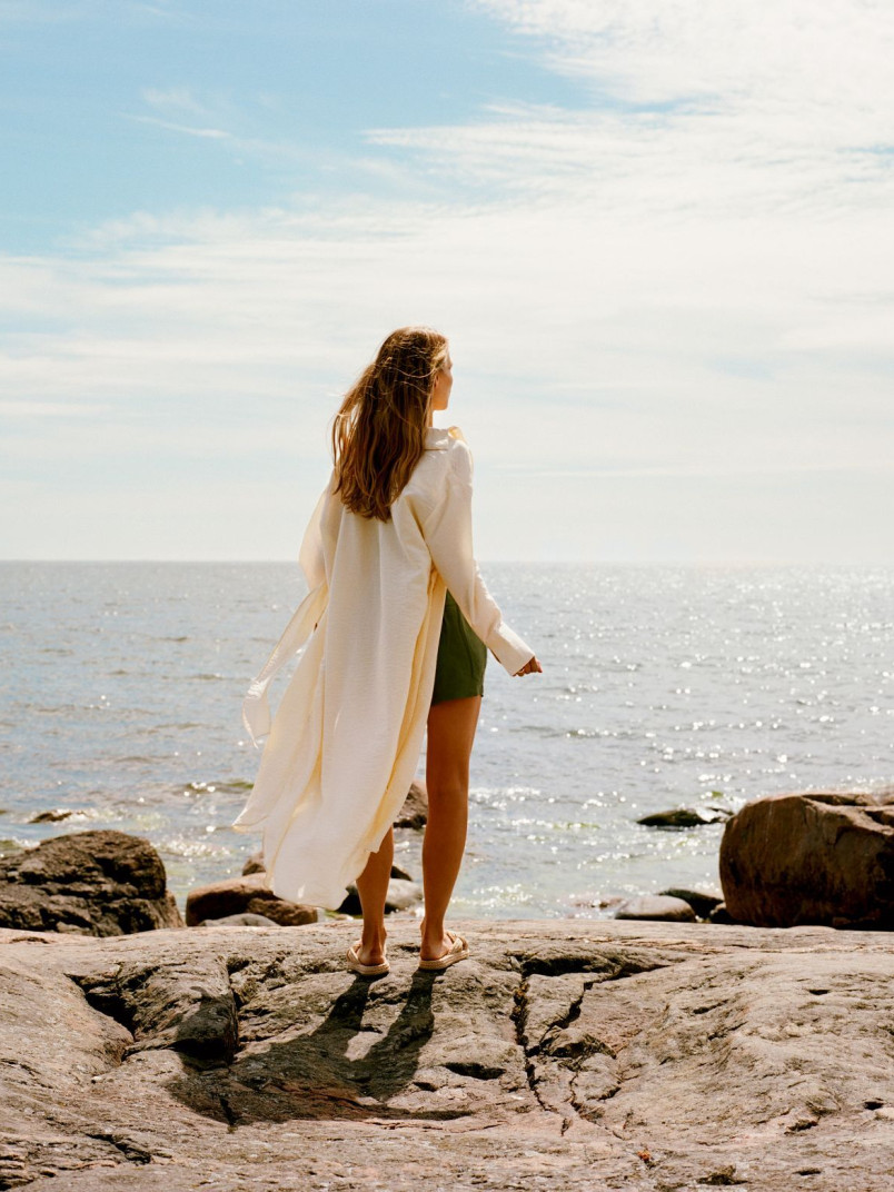 woman standing on rocky beach
