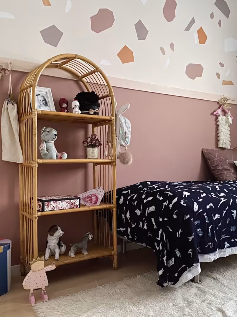 muted pink colour wall in kids room with colourful decorations