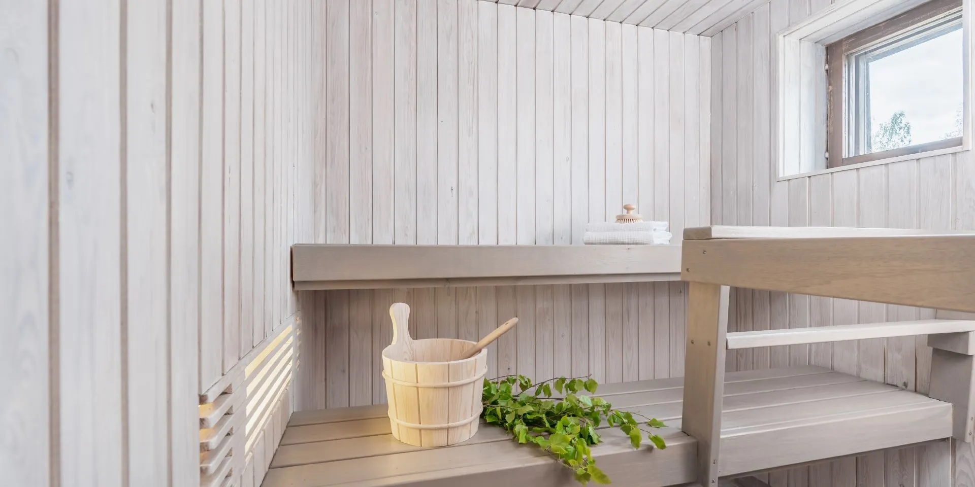 white colour sauna with light grey bench