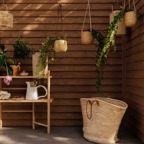 mother and daughter on terrace with gardening tools and furniture