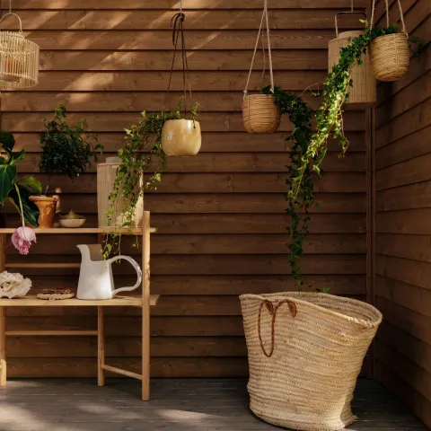 mother and daughter on terrace with gardening tools and furniture