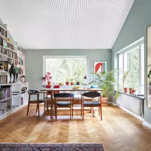 spacious living room with soft green colour wall