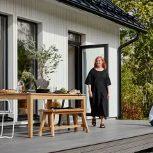 white wooden house, woman and son on terrace