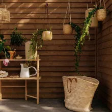 mother and daughter on terrace with gardening tools and furniture